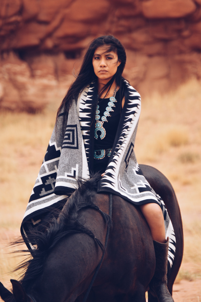Shondina Lee Yikasbaa with Naskan saddle blanket - posed on horseback