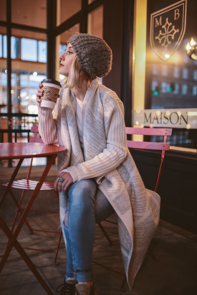 mikal_wright: a young woman enjoys her coffee in a coffee shop