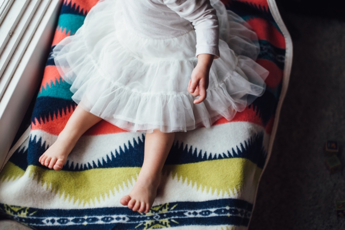 a baby sits on a Pendleton child's blanket. 