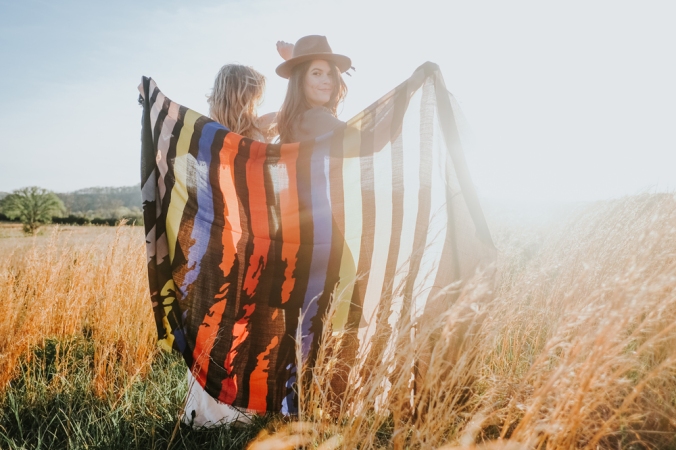 Two women and a scarf in a meadow.