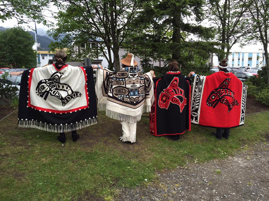 Linda and her family displaying their handmade robes and blankets. 