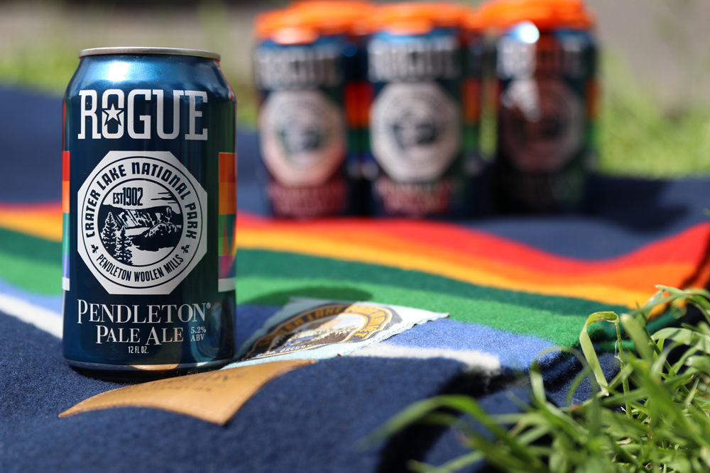A six pack of Rogue IPA on a Crater Lake national park blanket. 