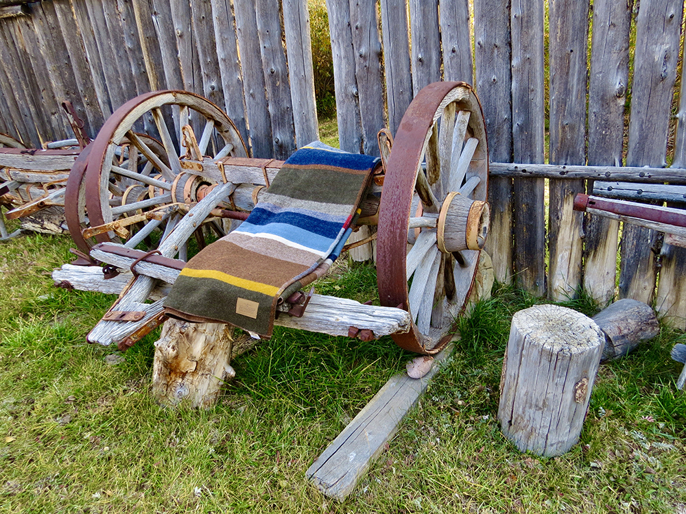 Pendleton Bridger Stripe blanket hanging on the axle of a pioneer wagon at Fort Bridger
