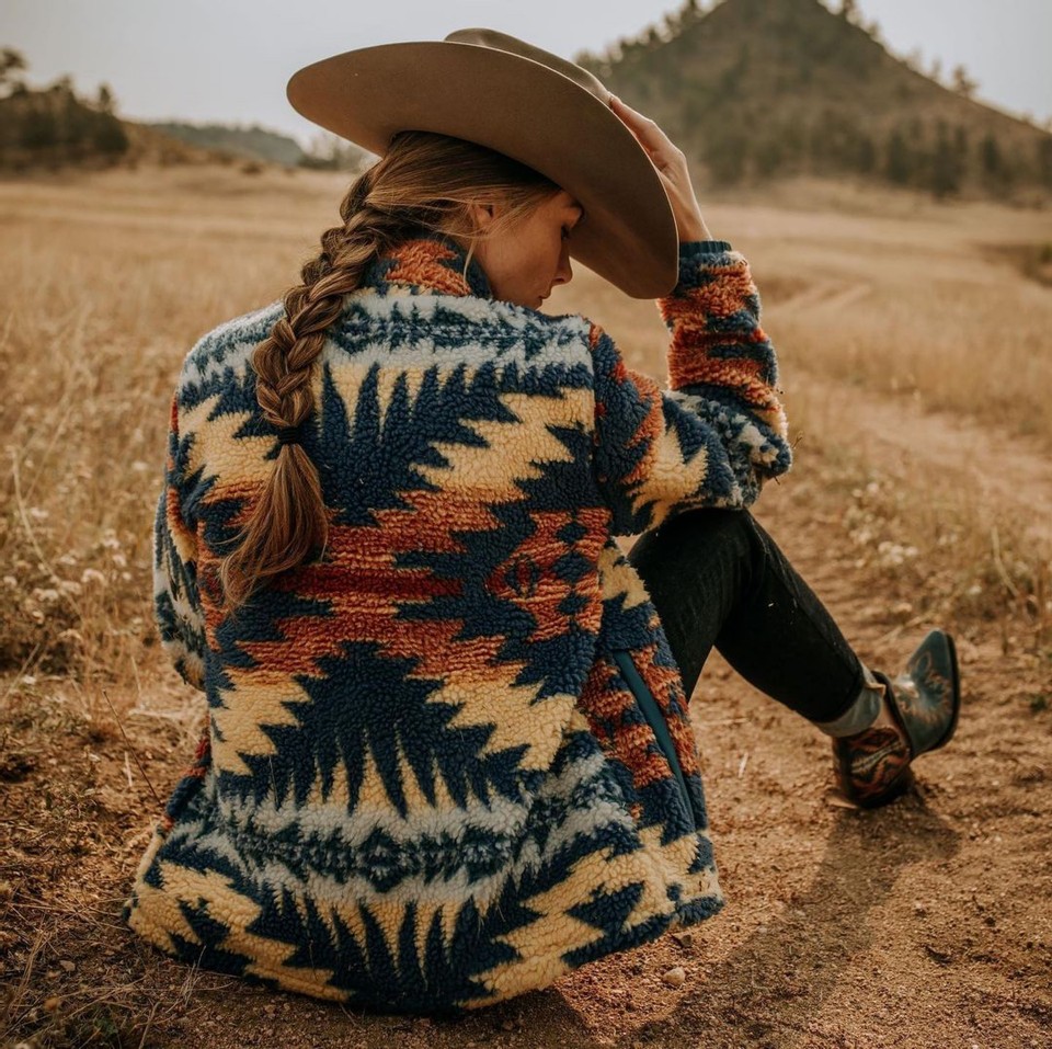 A woman in a Pendleton patterned jacket by Ariat